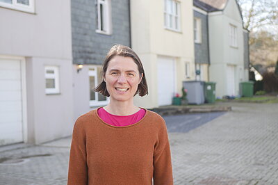 Ruth Gripper standing in front of housing