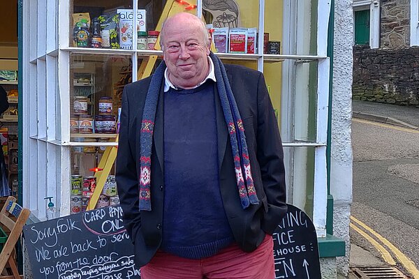 Councillor Pete Mitchell standing in front of Churchtown Stores greengrocer in St Agnes 